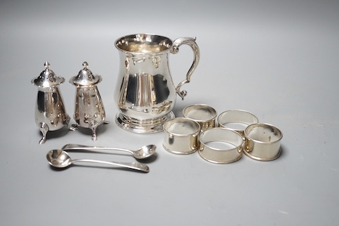 A George II silver baluster mug, John Payne, London, 1752, 97mm, together with five silver napkin rings, two silver condiment spoons and two silver pepperettes, 14oz.